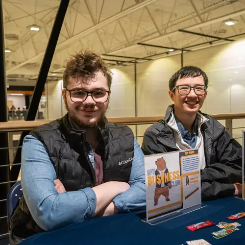 Business students sits at the club table during welcome weekend