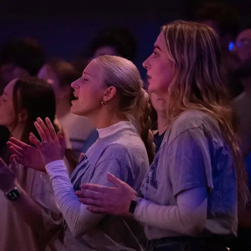 Two christian athletes participate in evening worship