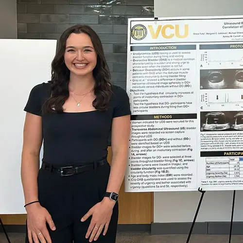 Grace Tully stands in front of her engineering project