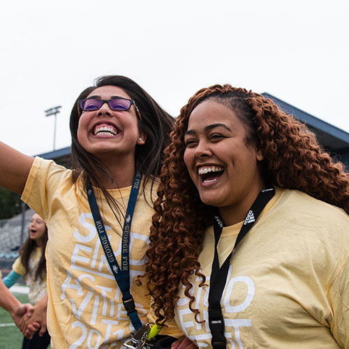 2 students laugh at the camera