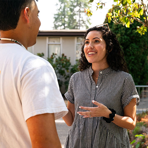 College student talking with an adult outside