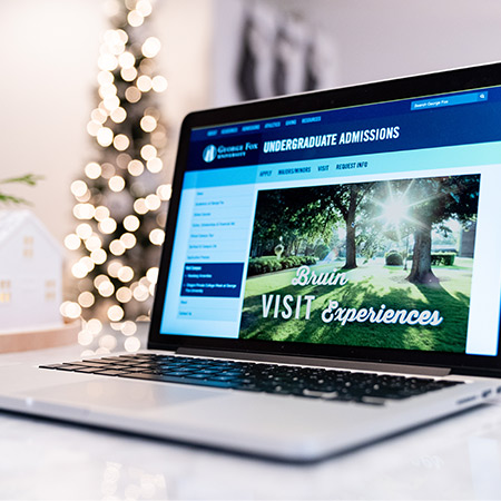 A laptop showing Bruin Visit Experience webpage