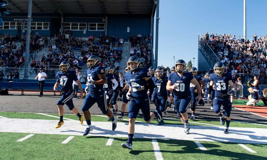 football players running onto the field