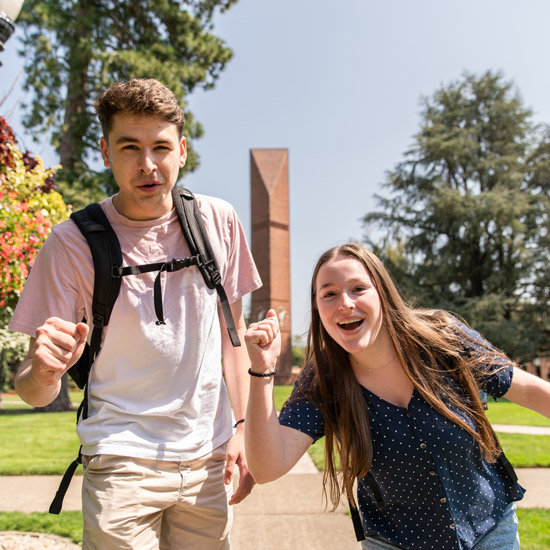 2 students smile at the camera