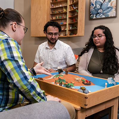 Counselor using a sandtray with a couple