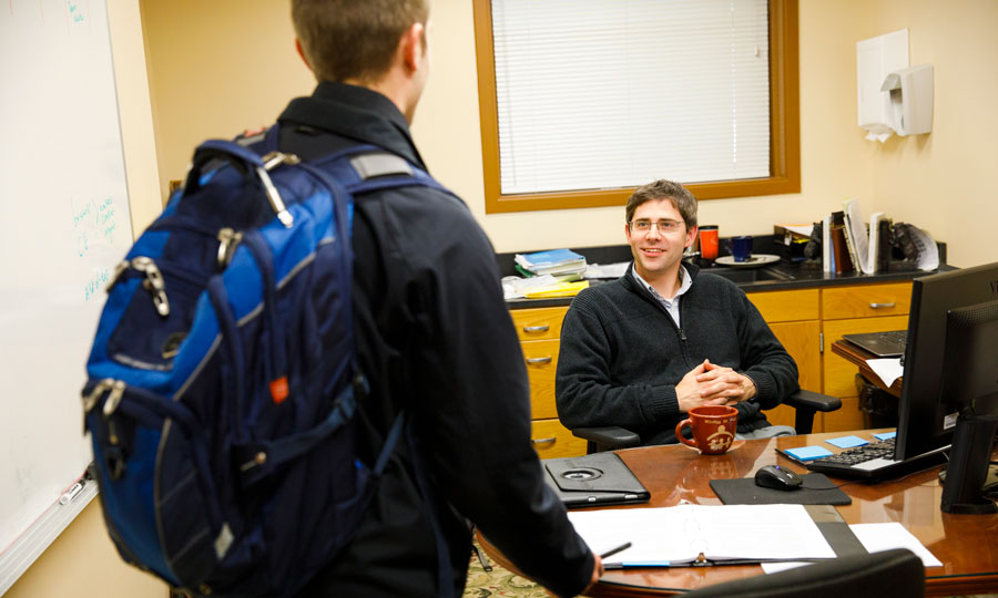 School counselor smiles at child