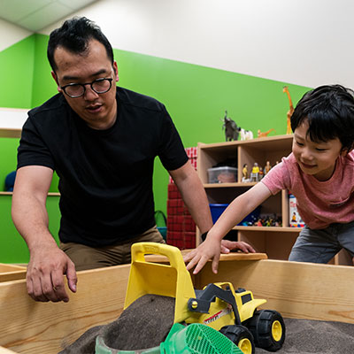 Professional counselor with a child during play therapy