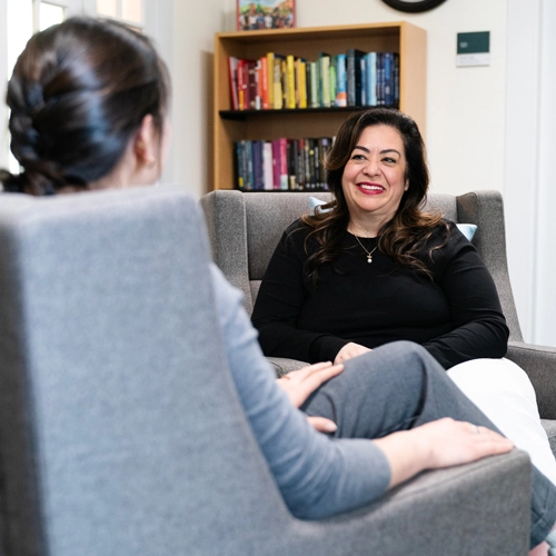 patient speaking to a counselor who is smiling