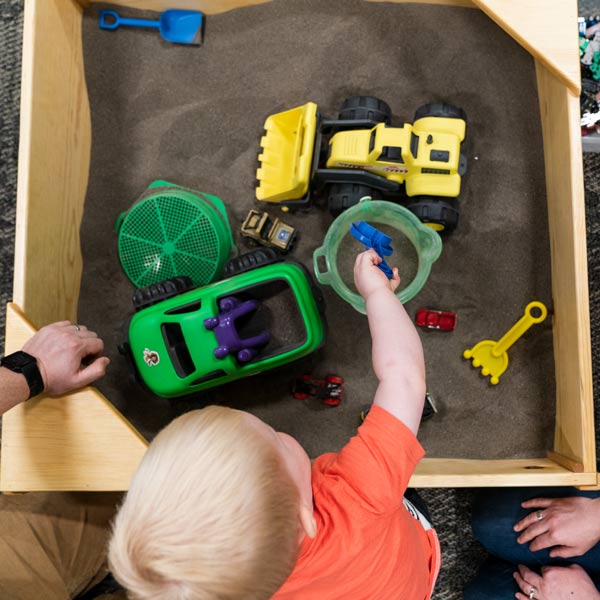 child plays in sand