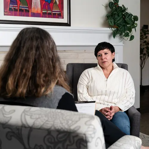 A counselor speaks gently with a client