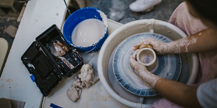 student works on ceramic wheel