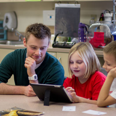 a teacher helps a child with classwork
