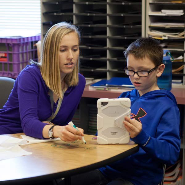 special education teacher with student