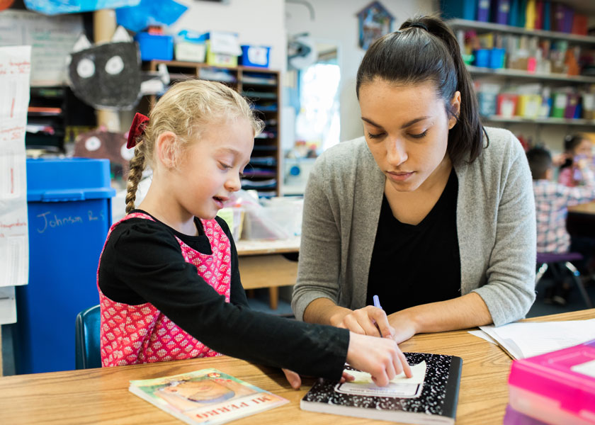Student teacher helps student learn to read