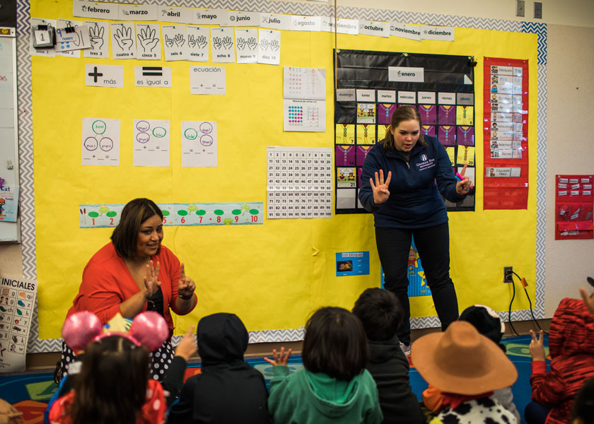 Teacher and student teacher teach a room of kids