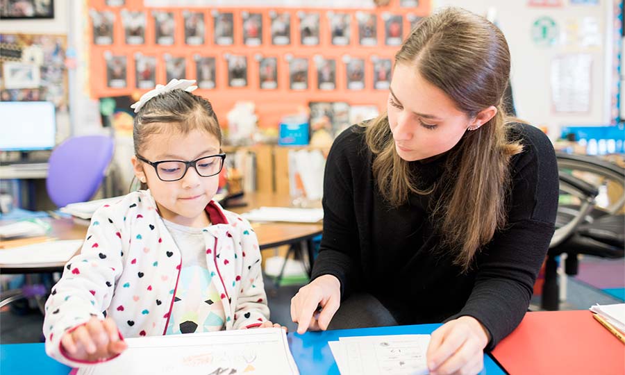 Teacher helping a student with assignments