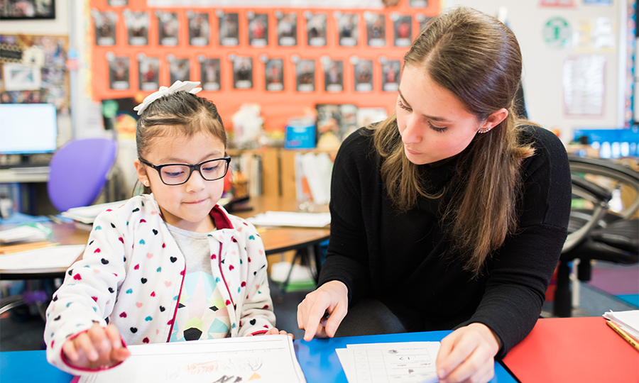 Teacher helping a student with assignments