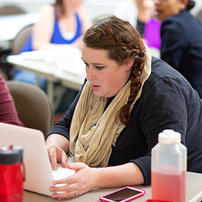 Student in the program is focused on her laptop