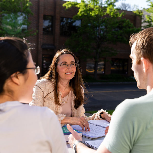 students in residency in classroom listen to elder professor