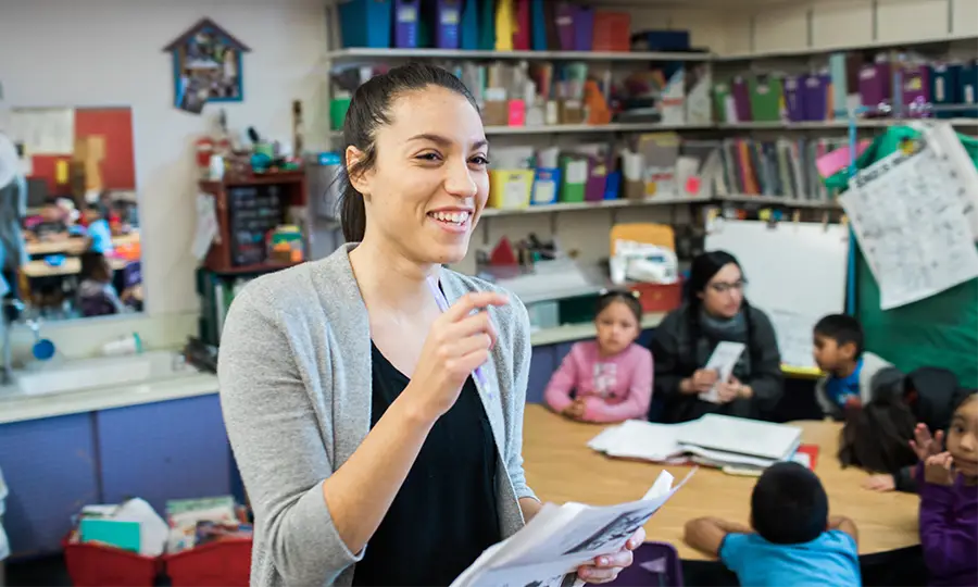 A student teacher smiling in her classroom
