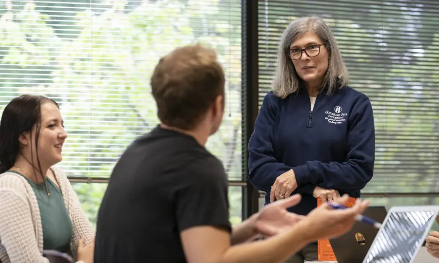 Professor listening to students in class