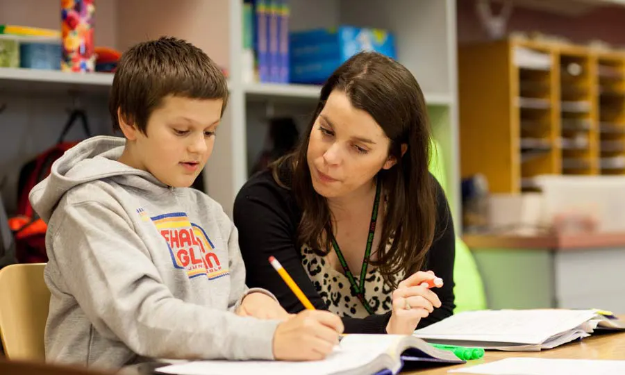 Teacher with pupil in a classroom