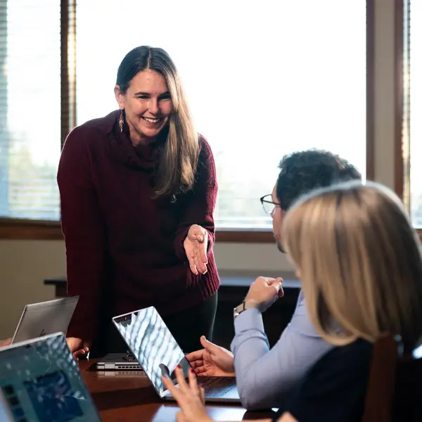 A female administrator talks to a group in a conference room