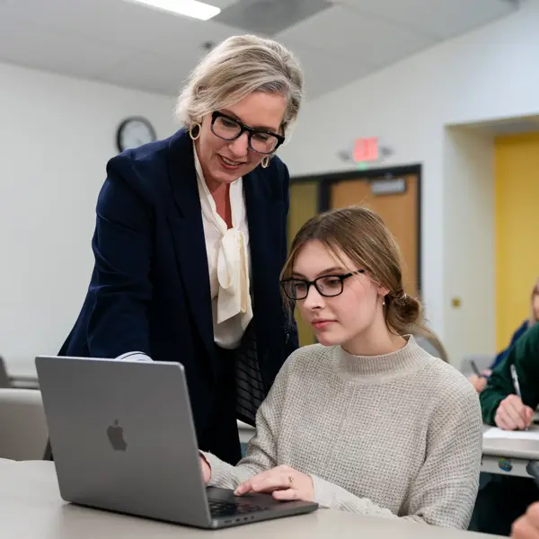 An educator talking with students