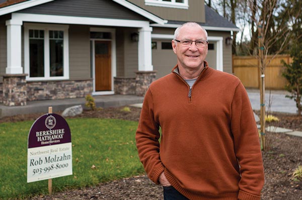 Rob stands in front of house