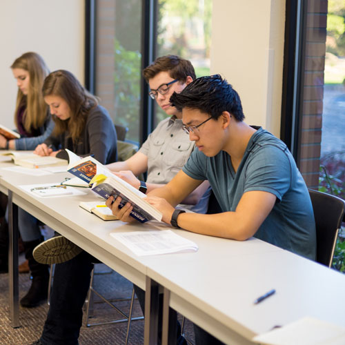 students in classroom reading books