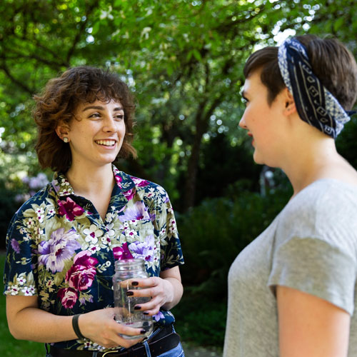 2 students chatting outside in the spring