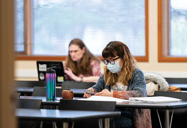 Student in classroom wearing a face mask.