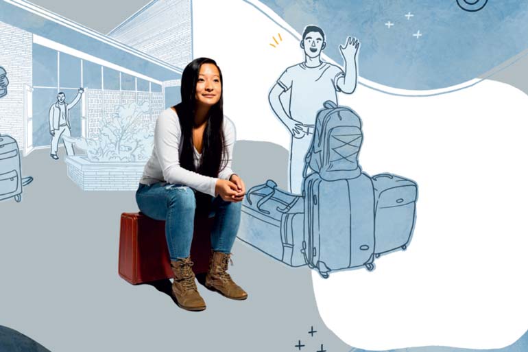 Student Faith sitting on a suitcase