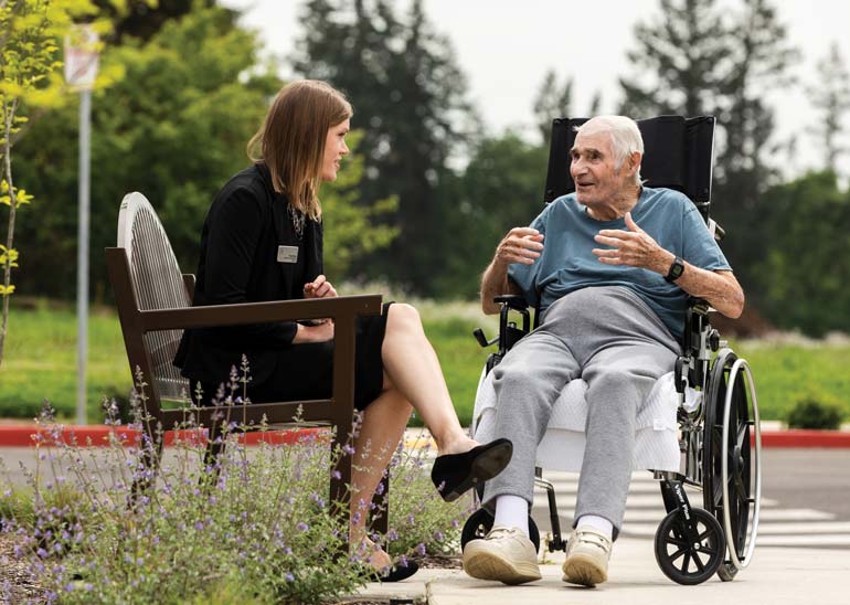 Tracy speaking with an elder