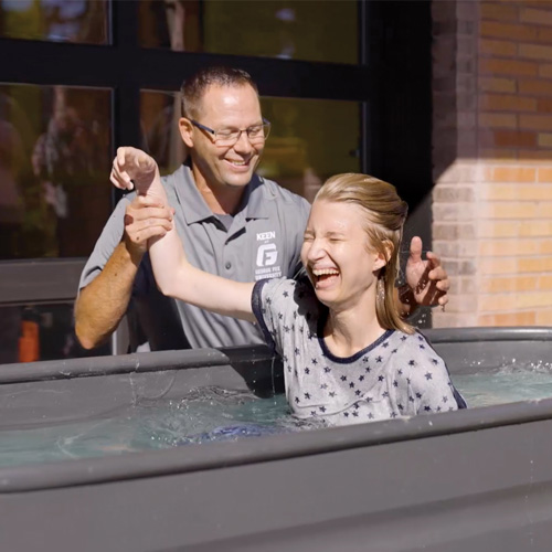 Emma emerges from the tub smiling after baptism