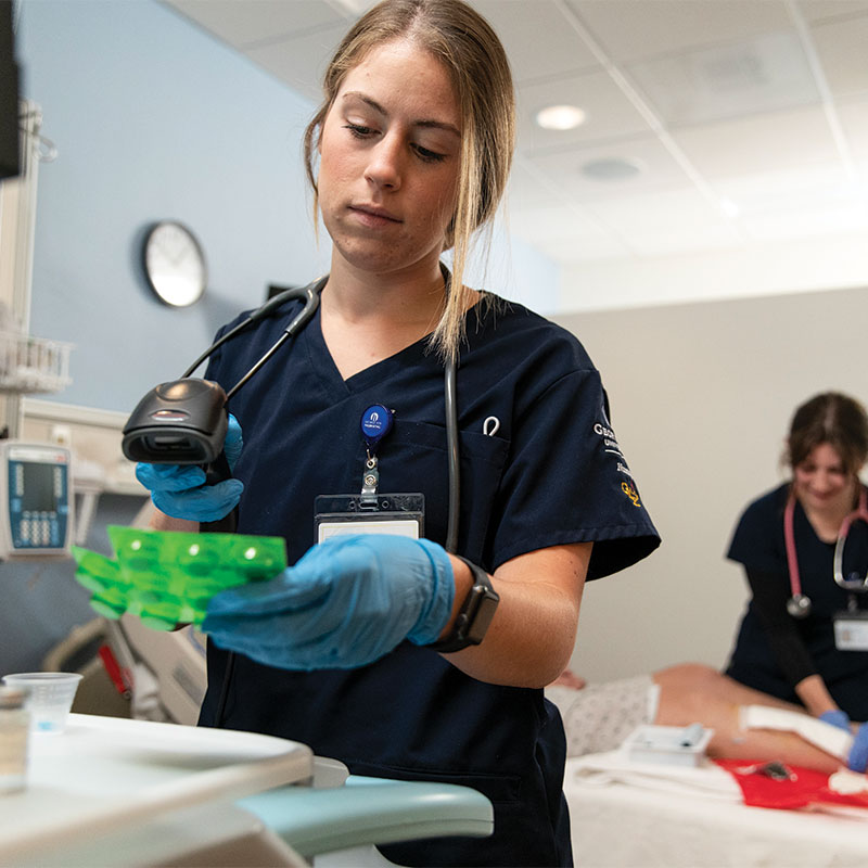 Nursing students treat a “patient” actor in one of the Fox Health simulation rooms. 