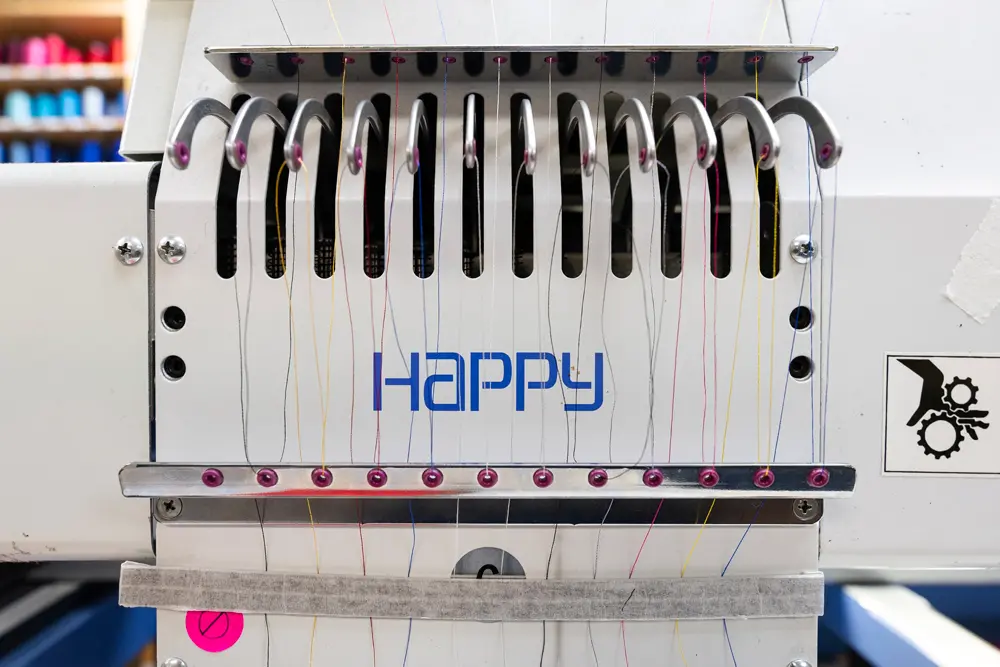 Happy embroidery machine with thread in it at Righteous Clothing Agency