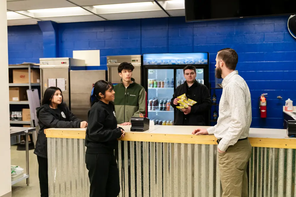 Roy engaging with Marketing and Business Management students in the Scot Shop, a student-run store