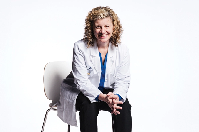 portrait of Pam Fifer sitting in a chair smiling