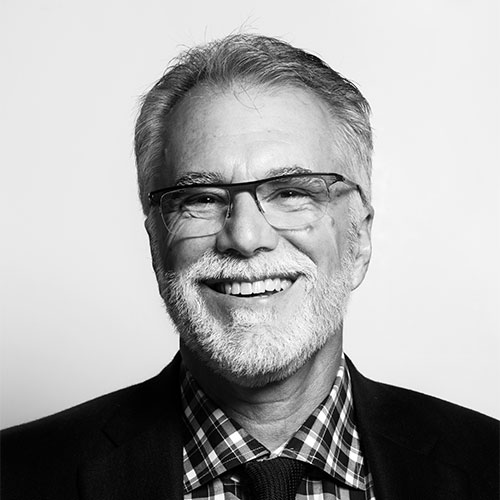 Robin Baker smiling in black and white