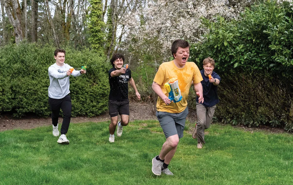 Sam runs from housemates in a water gun fight