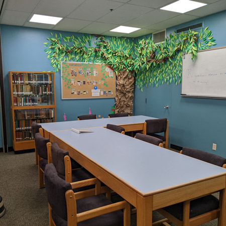 Library shelves with tables and chairs