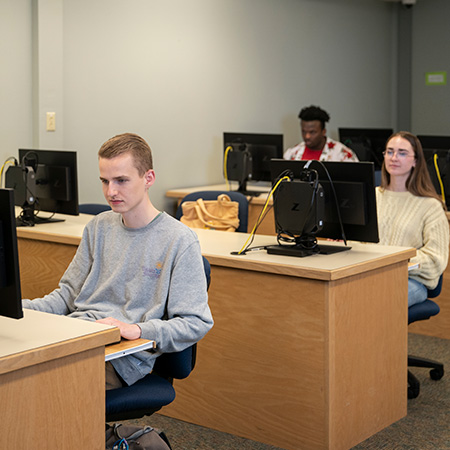 Students in the computer lab classroom in the library
