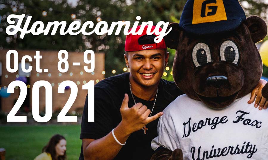 Student standing with mascot Pennington bear