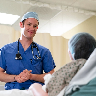 A CRNA talking to a patient