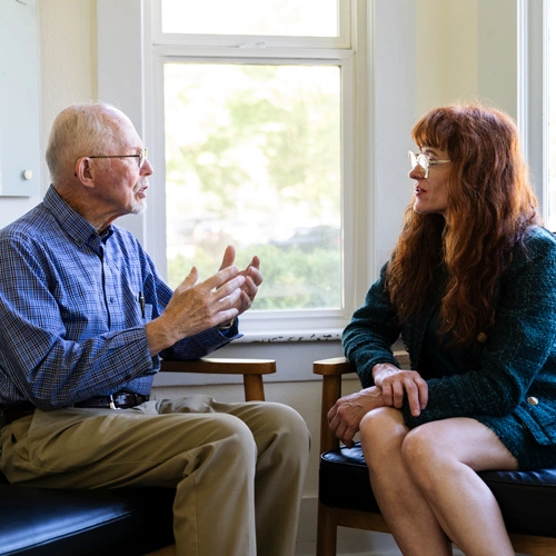 PMHNP listening to an elderly patient