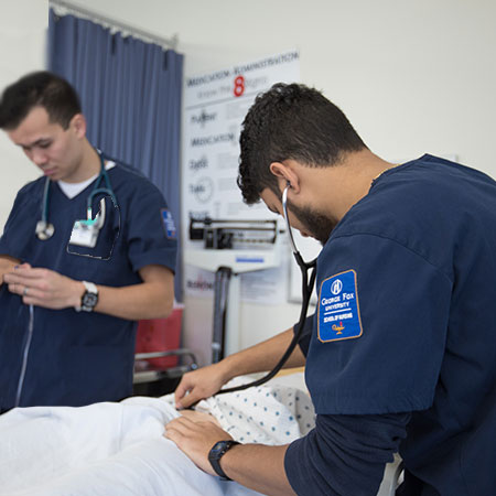 Two nursing students working in a simulation lab
