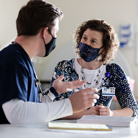 A nursing student talking with a professor