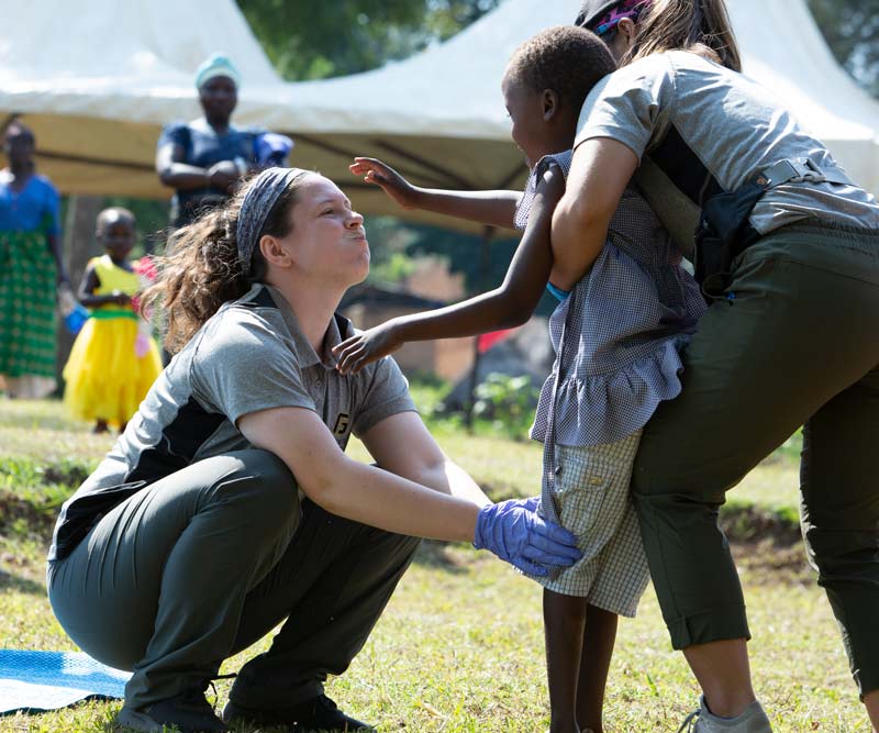 Students play with child on serve trip