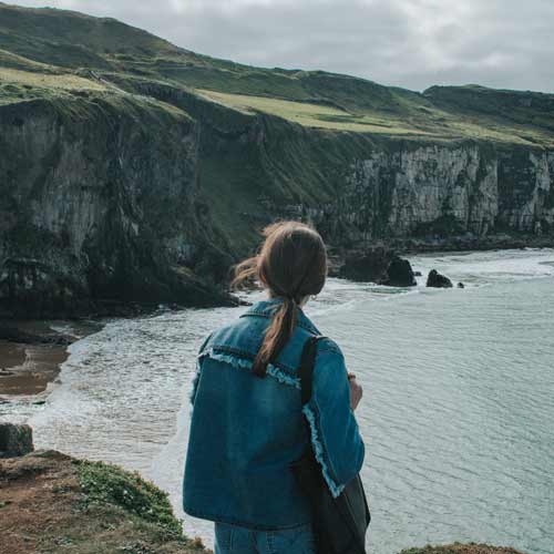 A girl looks out on a scenic landscape